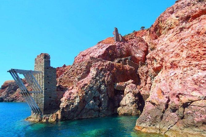 Best of Milos and Poliegos Catamaran snorkelling Cruise with BBQ - Tsigrado: pass-by photos of a beach accessed by ladders and ropes