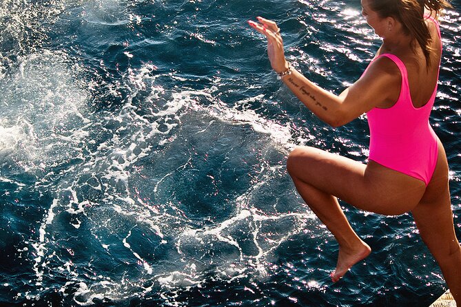Boat Party with Swimming Stop Experience in Mykonos - A swim stop near Rhenia Island