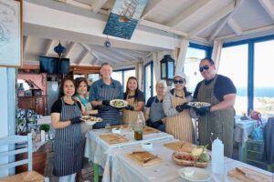 Cooking Class and Wine Tasting in Santorini - Pagonis Estate setting: views, black-beach vibes, and a working courtyard kitchen