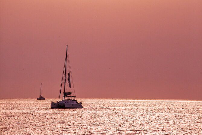 Deluxe Santorini Sailing with BBQ and Drinks Shared Tour - Deluxe catamaran basics: transfers, time on the water, and group size