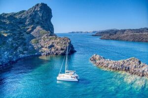 Deluxe Santorini Sailing with BBQ and Drinks Shared Tour - Sailing by the Lighthouse and Indian Head Mountain: the coast views you can’t fake