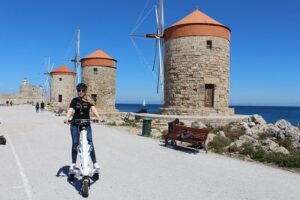 Explore the new town and the medieval town of Rhodes on scooters - 3 hours - Mandraki Harbour and the “new town” ride with Knights’ Castle in view