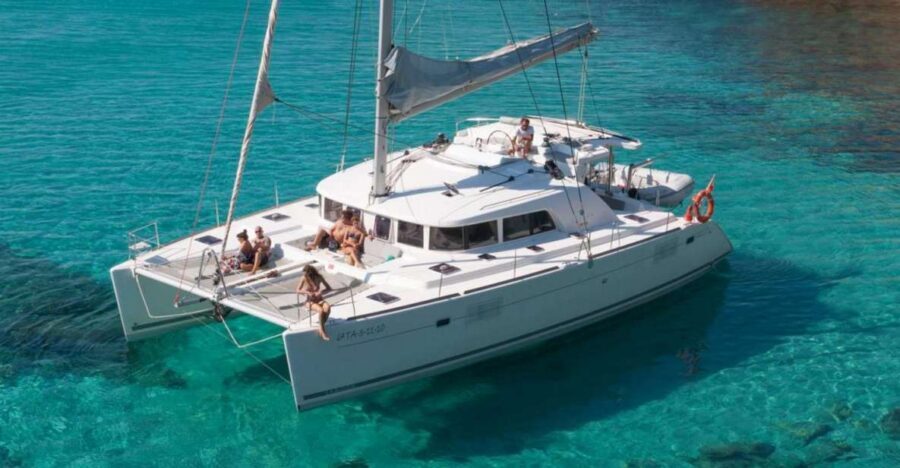 From Adamas: Milos and Poliegos Catamaran Cruise with Lunch - Kleftiko caves, paddleboarding, and BBQ lunch in the best kind of chaos