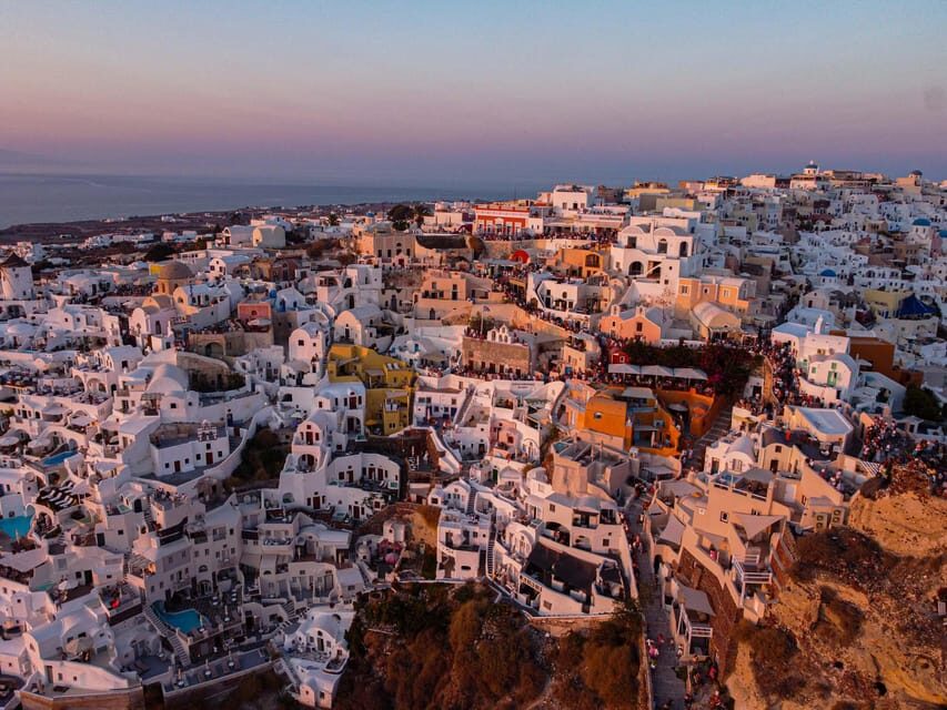 From Fira: Santorini Highlights Minibus Tour with Oia Sunset - Perissa Beach free time for swimming, sunbathing, and lunch choices