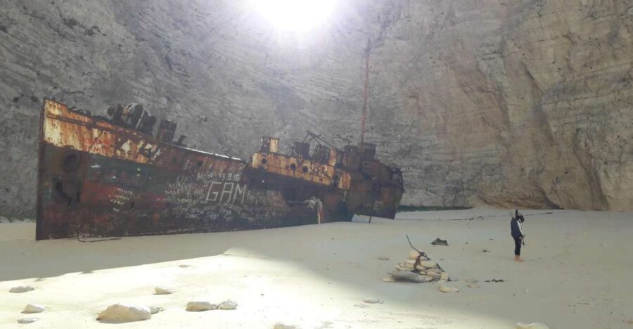 From St.Nikolaos: Boat Cruise to Navagio Beach & Blue Caves - Blue Caves: glass-bottom viewing, electric-blue water, and a swim stop