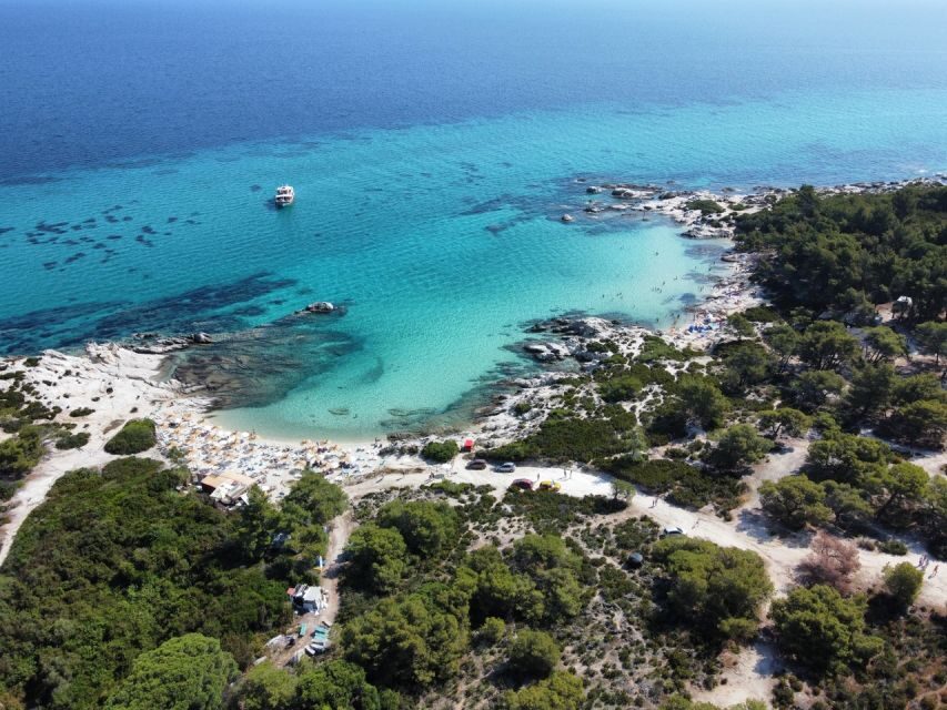 From Thessaloniki: Sithonia Beaches and Scenic Villages Tour - Neos Marmaras: marina walk, shops, and views toward Mount Athos