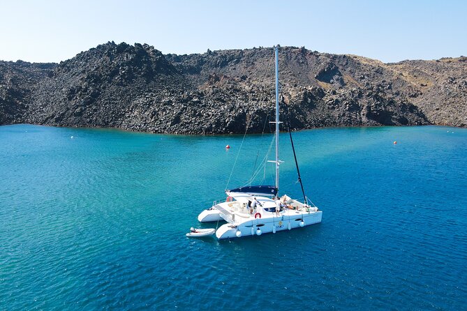 Full Day Santorini Catamaran Private Cruise with meal and transfer - Faros lighthouse and the Indian Head rock