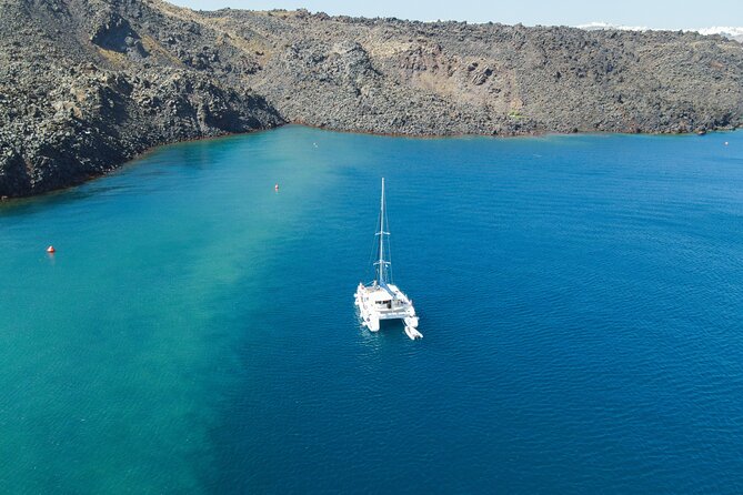 Full Day Santorini Catamaran Private Cruise with meal and transfer - Oia from below, not from the famous lanes