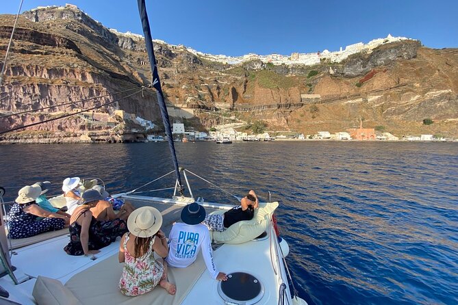 Full Day Santorini Catamaran Private Cruise with meal and transfer - Red Beach: volcanic color and a crowded little shore