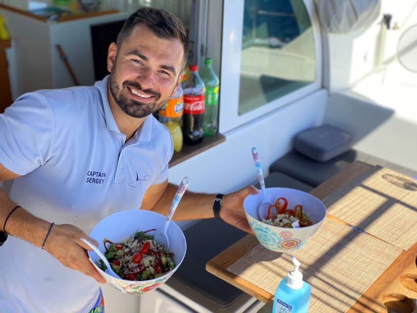 Heraklion:Dia Island Catamaran Cruise with Lunch, Water Toys - Catamaran time: sunbeds, shaded lounges, Wi‑Fi, and the music setup
