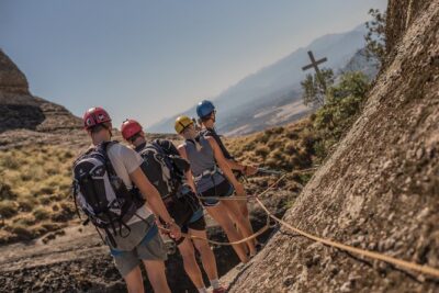 Meteora Scrambling Tour with Optional Pick-up - Getting fitted for the climb beneath Kimisis Theotokou