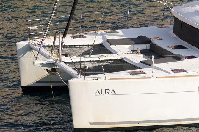 Mykonos Catamaran Sunset Cruise with Meal, Drinks & Transfer - Stop 1: Psarou Beach for turquoise views and sunset photos