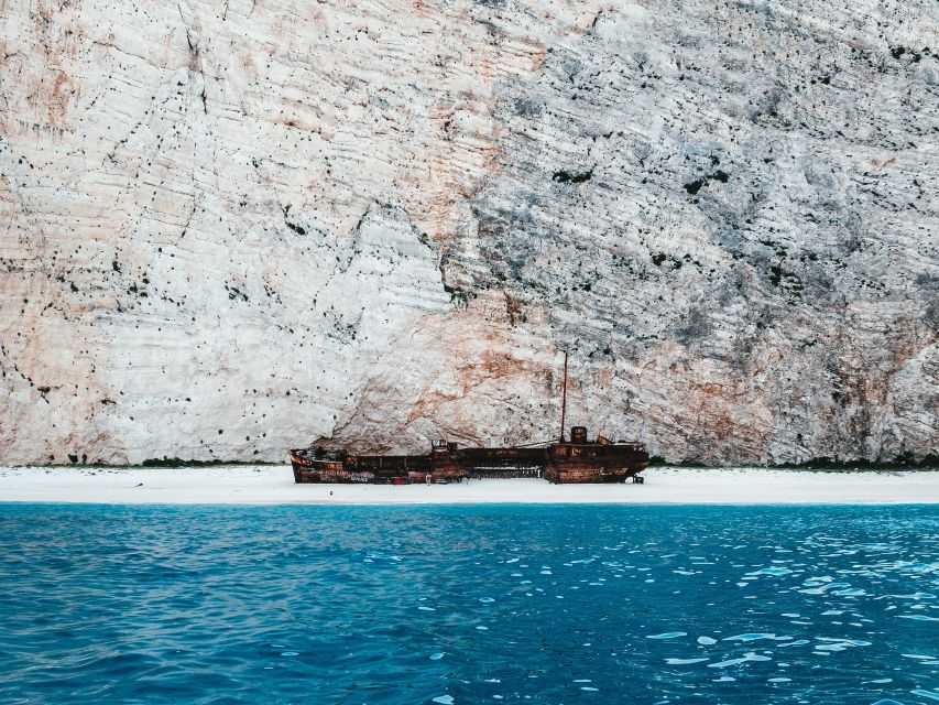 Porto Vromi: Navagio Shipwreck Cruise with Sunset Viewing - Leaving tiny Porto Vromi behind
