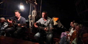 Rhodes: Night Cruise with Live Music and Sightseeing. - Mandraki Harbor to the Medieval Walls: How Your 90 Minutes Unfold