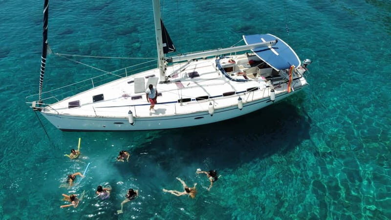 Rhodes: Sunset Catamaran Cruise with Snack, Fruits & Drinks - Kalithea Springs Bay Stop: Swim, snorkel, paddle, and explore the caves