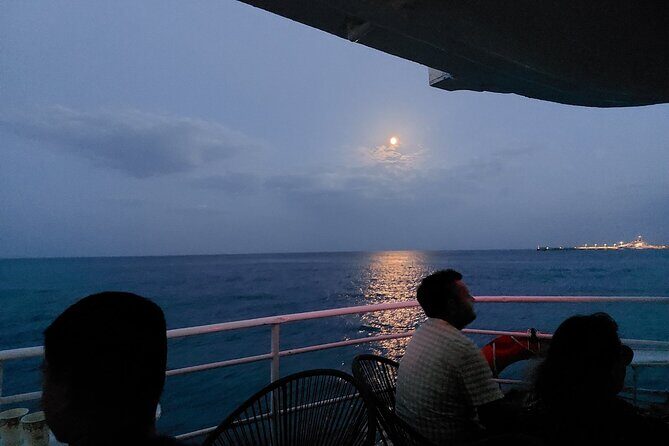 Rhodes Sunset Cruise - Swim and Dine w/ Live Music & Sunset! - Cruising back: illuminated medieval walls and multiple harbor angles