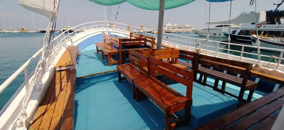 Rhodes: Sunset Cruise to Kallithea with Drinks and Snacks - Passing Faliraki with a camera ready