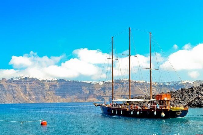 Santorini Caldera Morning Cruise With King Thiras Boat - Sailing back below Oia: views that only make sense from the deck