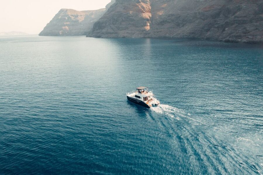 Santorini: Caldera Private Power Catamaran Cruise - Where the water time really happens: decks, snorkeling, and a ~30-minute beach stop