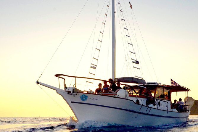 Santorini Caldera Sunset Traditional Cruise with Meal and Drinks - Akrotiri lighthouse: a classic sailing-by landmark
