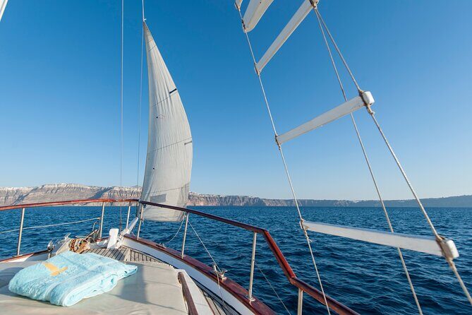 Santorini Caldera Sunset Traditional Cruise with Meal and Drinks - Red Beach: minerals, photos, and a quick swim chance