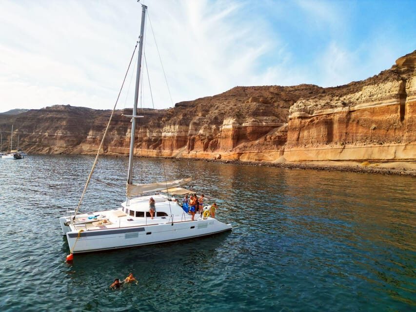 Santorini: Catamaran Cruise with Greek BBQ and Drinks - Red Beach: the first swim stop you’ll talk about later