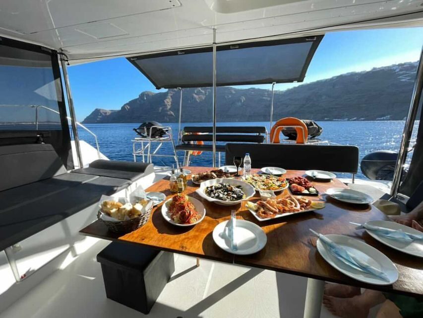 Santorini: Catamaran Cruise with Lunch, Drinks, & Oia Visit - Volcano caldera passes and classic photo moments