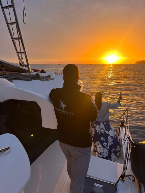 Santorini Catamaran Cruise with Swimming, Meal and Open Bar - Caldera views from the water: White Beach, the Akrotiri Lighthouse, and more