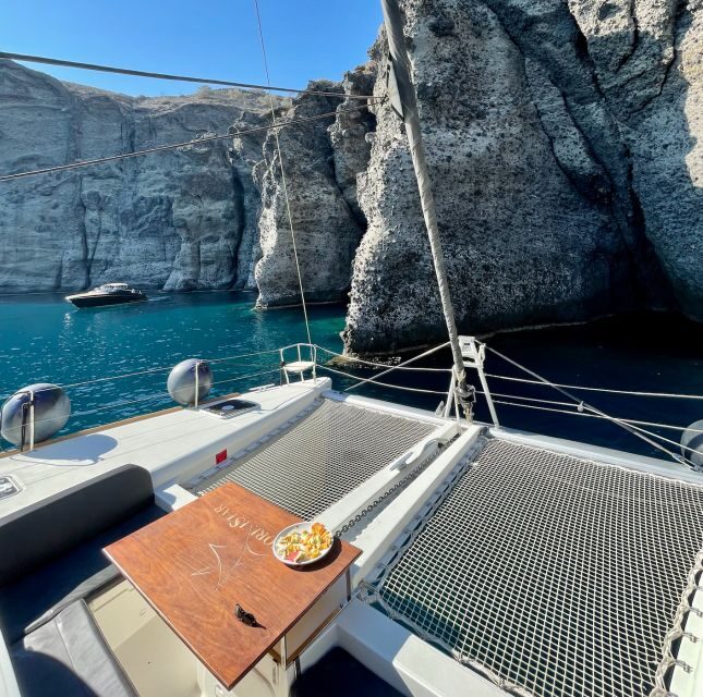 Santorini Catamaran Cruise with Swimming, Meal and Open Bar - Red Beach swim stop: volcanic color with an easy, safe approach