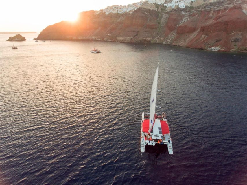 Santorini: Cruise Catamaran with BBQ & Drinks Day or Sunset - Red Beach: swimming and snorkeling with less friction