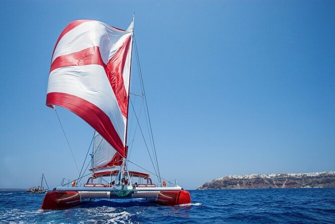 Santorini Cruise on Catamaran with BBQ & Open Bar - Sailing past the Old Lighthouse and Indian Rock