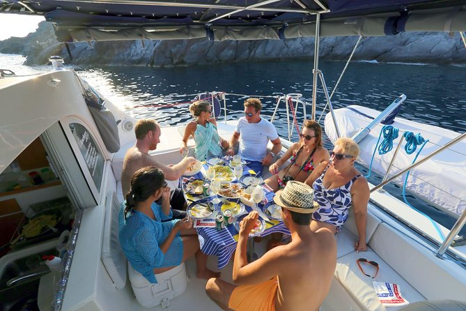 Santorini Full Day Catamaran Private Cruise incl. Meal, Drinks & Free Transport - The Akrotiri lighthouse and the island’s southwest edge