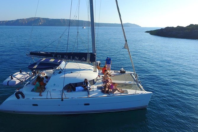 Santorini Full Day Catamaran Private Cruise incl. Meal, Drinks & Free Transport - Oia, Imerovigli, and Firostefani from below