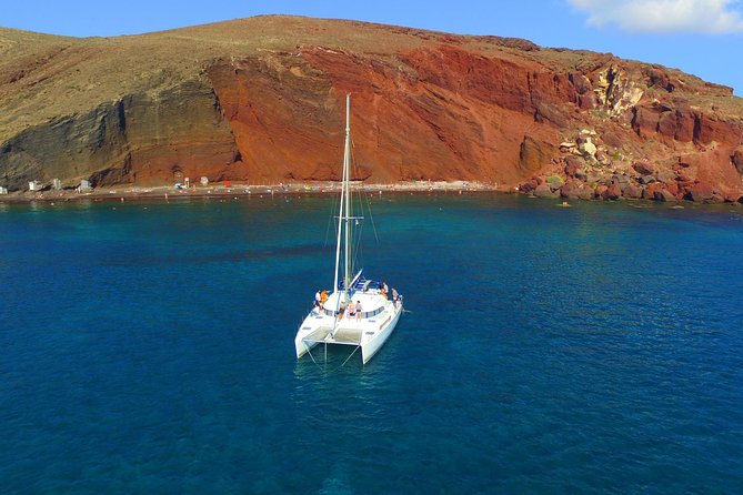 Santorini Full Day Catamaran Private Cruise incl. Meal, Drinks & Free Transport - Red Beach and White Beach from the water