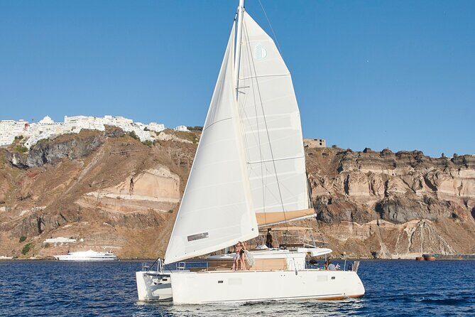 Santorini Gold Catamaran Cruise with BBQ, Drinks and Hotel Pickup - Mesa Pigadia beach: where BBQ and a swim happen together