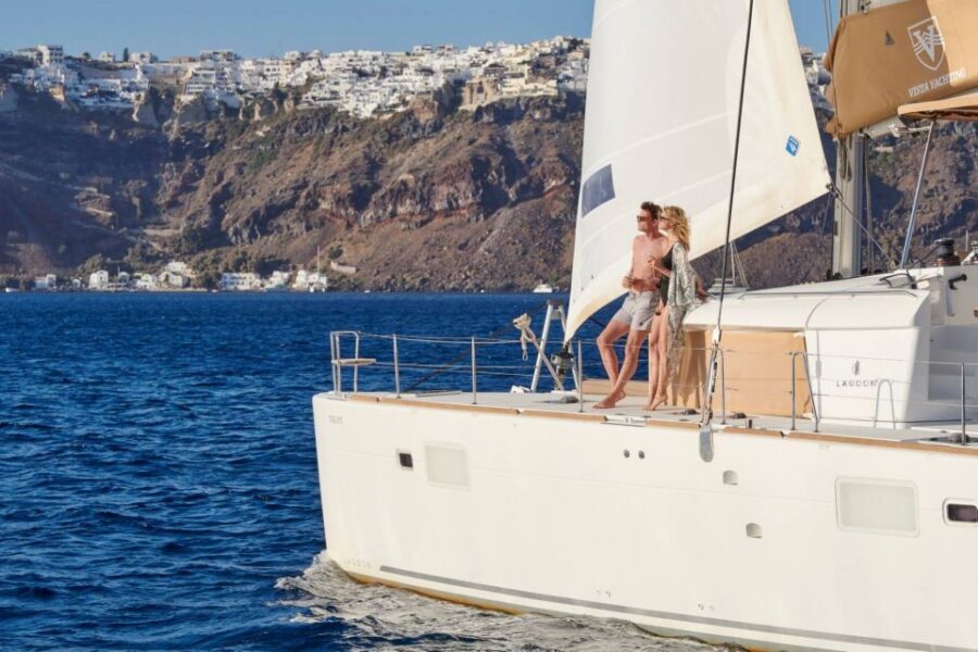 Santorini Gold Catamaran Cruise with Snorkel, BBQ & Open Bar - Getting to the boat: Vlychada Marina, welcome drinks, and a clear start