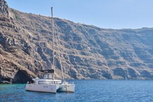 Santorini: Luxury Catamaran Cruise with Fresh Fish BBQ & Drinks - Red Beach and the Color Shift to White Beach