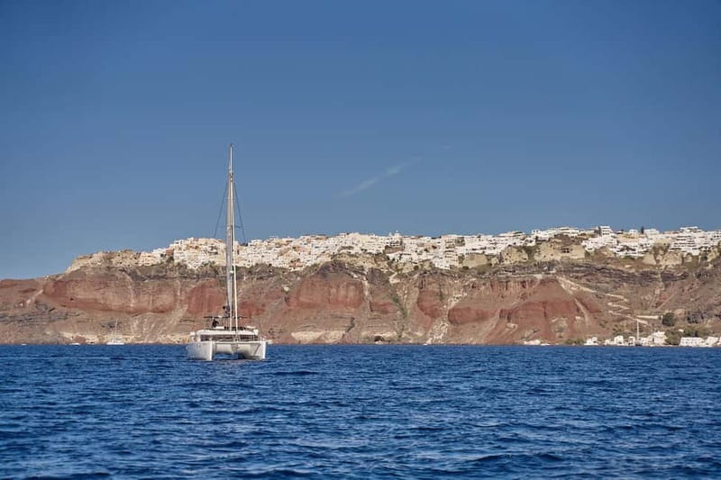 Santorini Oia: Caldera Day Cruise with Snacks & Drinks - Leaving Ammoudi Bay beneath Oia