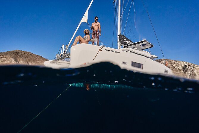 Santorini Oia: Luxury Sunset Cruise with Fresh Fish BBQ & Drinks - Red Beach: the best mix of scenery and onboard dinner