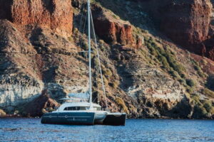 Santorini: Private Catamaran Cruise with BBQ Meal and Drinks - Thirassia and the view of Manolas: calmer water, quieter scenery