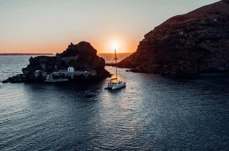 Santorini: Private Catamaran Cruise with BBQ Meal and Drinks - Aspronissi and boat-only coasts: where the caldera feels close