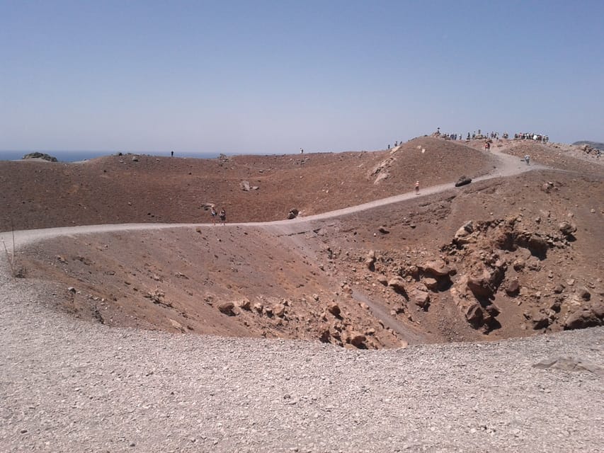Santorini: Private Motorboat Cruise and Volcano Hike - Leaving Ammoudi Harbor below Oia