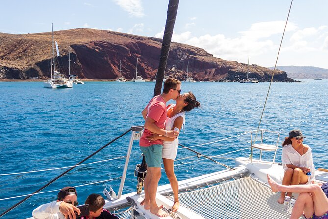 Santorini Sailing Catamaran Daily Cruises w/ Greek BBQ @Thirasia - Red Beach: 20 minutes beside volcanic cliffs