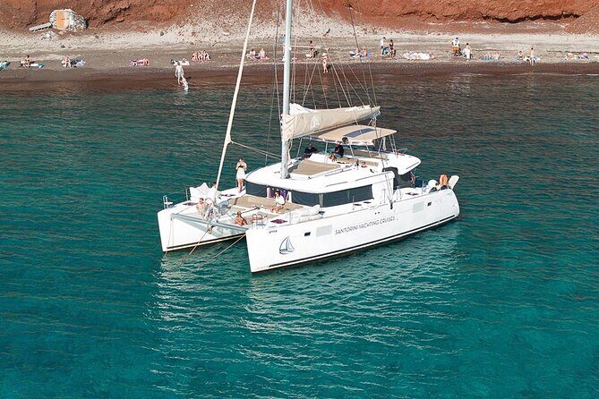 Santorini Sunset Sailing Cruise: Dinner, BBQ, Open Bar, Transfers - The sail-by stretch: White Beach, Indian Rocks, and the Venetian Lighthouse