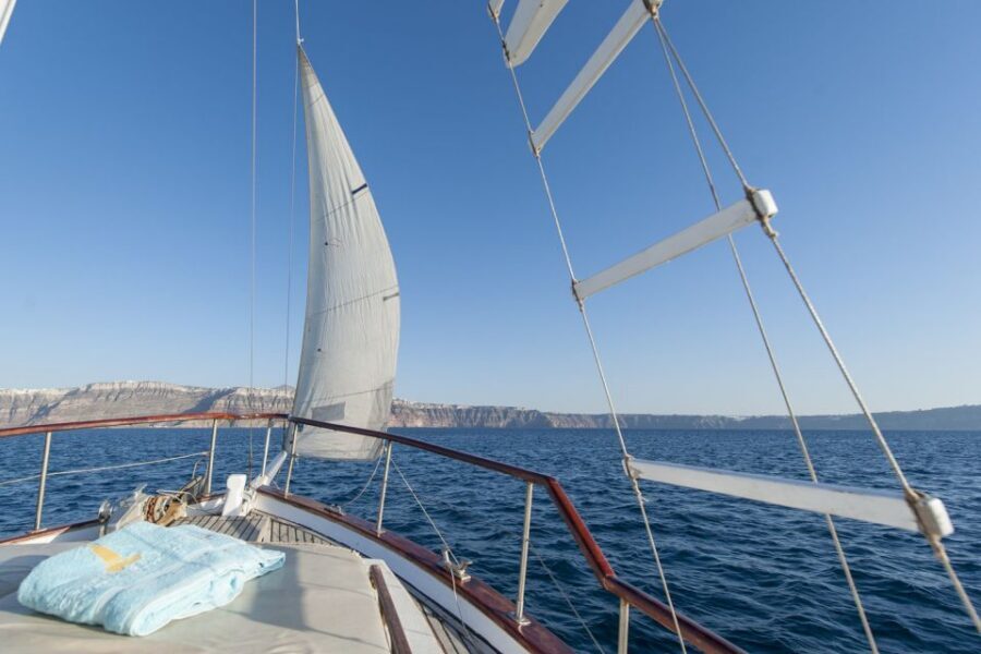 Santorini: Traditional Wooden Boat Tour with Meal and Wine - Volcanic hot springs at the Santorini Volcano: geothermal energy, not just a stop