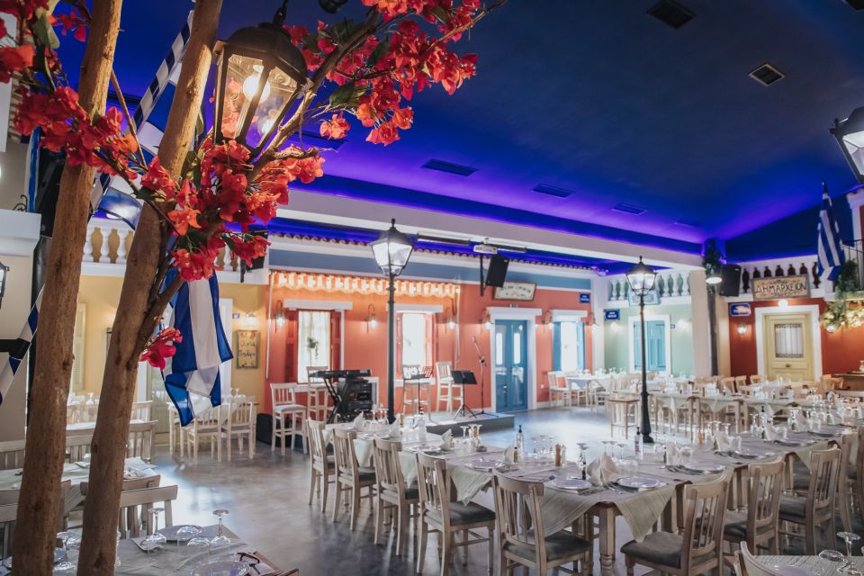 The Popolaros Evening: Food, Drinks & Live Greek Dancing - The village-square setting at Popolaros Taverna