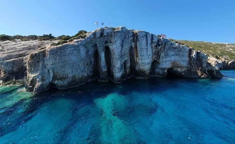 Zakynthos: Blue Caves and Navagio Bay Swim Cruise - Past a natural arch and monastery ruins