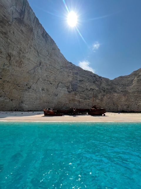 Zakynthos: Glass-Bottom Boat to Navagio, Caves & White Beach - White Beach: boat-only access and the rock tower tradition